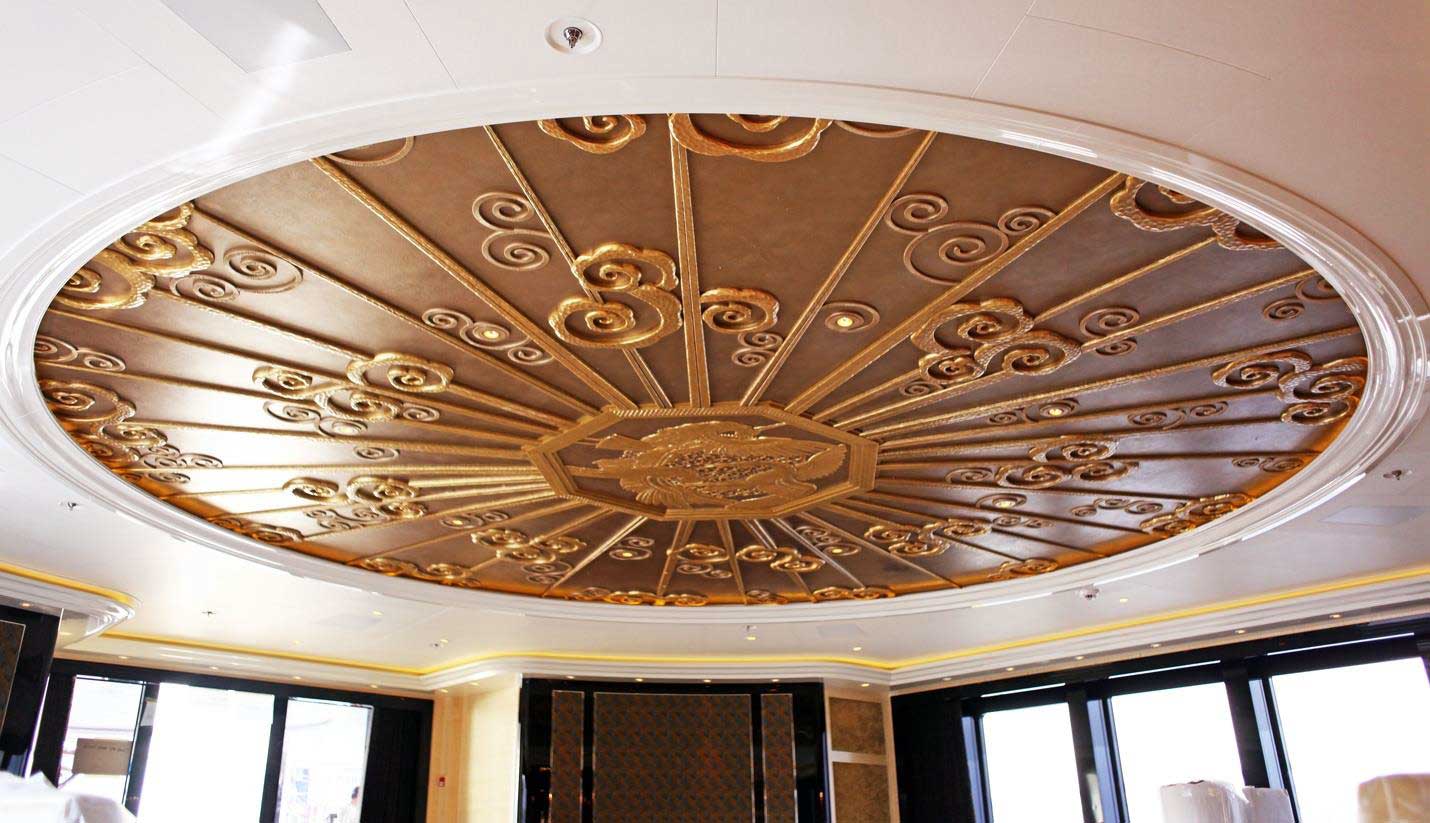 gold detailing on smooth wood surface on ceiling