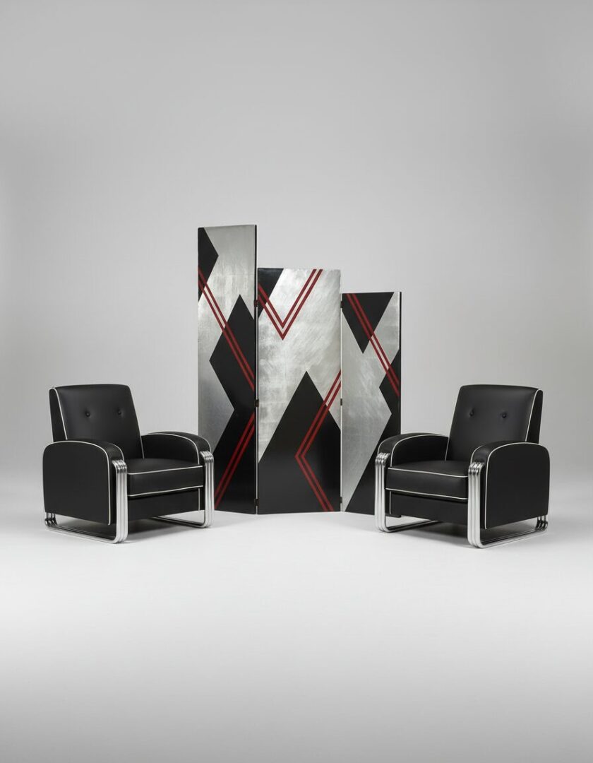 Two black leather armchairs flanking a modern geometric room divider with silver, black, and red accents.